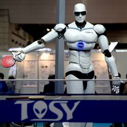 A humanoid robot plays ping pong.