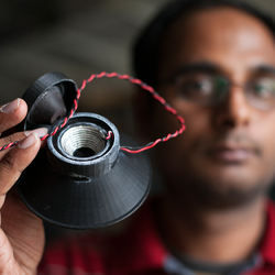 Graduate student Apoorva Kiran with his 3D-printed, fully functional loudspeaker.