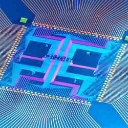 A nanowire finite-state machine (in false color) occupies the small central region of the chip with all other features corresponding to metal lines used to test the integrated system.