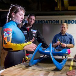 Olympians and Doug Bohl with luge sled