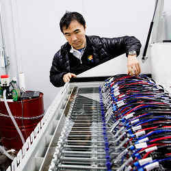 Project leader Satoshi Matsuoka with the mineral oil-cooled Tsubame KFC supercomputer.