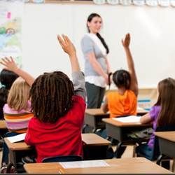 Elementary school girls participating in class. 