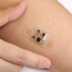 This stick-on patch stretches and moves with the skin, and incorporates electronics for wireless health monitoring.