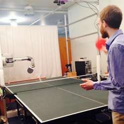 Jared Glover provides feedback to the ping-pong-playing robot after every swing..