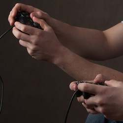 Videogamers using standard game controllers. 