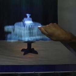 MisTable, a reach-through tabletop display screen.