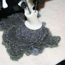 A 3-D printer feeds yarn into desired shapes and uses a needle to turn the yarn into a loose felt.