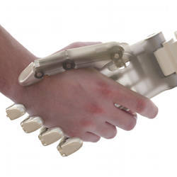 A robot shaking hands with a human.