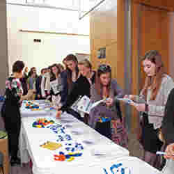 Students who participate in STEM pick up literature on engineering careers in transportation at a U.S. Department of Transportation workshop.