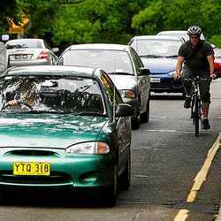 A bicyclist in traffic.