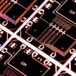 An integrated circuit with five quantum bits (crosses), for a quantum computer.