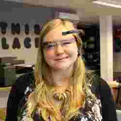 A woman wearing Google Glass and a device that measures the brain's electroencephalogram activity.