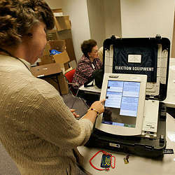 A woman selects a candidate during an early test of electronic voting.
