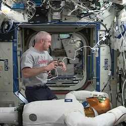 NASA astronaut and International Space Station commander Steve Swanson with Robonaut 2. 