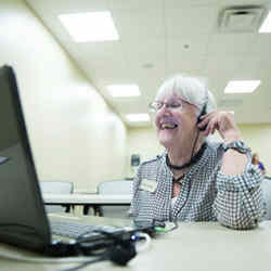 A woman enjoys a conversation with a Brazilian student learning how to speak English via Skype.