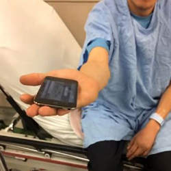A patient using the Tremor app to measure alcohol withdrawal tremors.