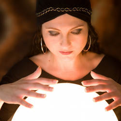 A mystic searches her crystal ball for images of the future.