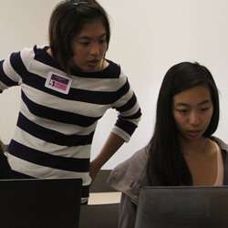 Sandra Lamantas (left) works with teammate Julia Yang during the 2014 International Women's Hackathon.