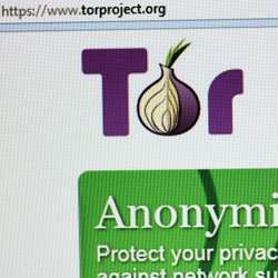 A computer monitor shows the Tor Project Web site landing page. 