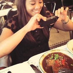 girl photographing food