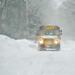 A schoolbus braving snowy roads. 