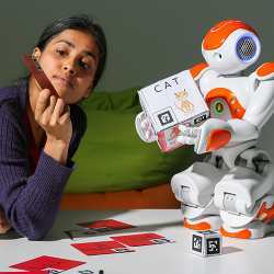 A student helps a robot learn how to write. 