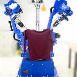 A robot handles a sweater.