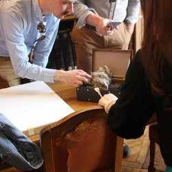 The team examining a Herculaneum scroll in the library of the Institut de France.