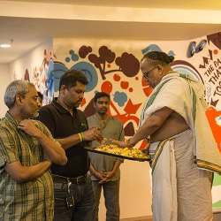 Freshdesk CEO Girish Mathrubootham (center) and a Hindu priest offering flowers in a ceremony to mark the opening of Freshdesk's new office in Chennai in January.