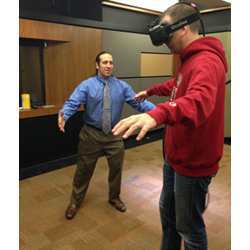 Stanford University Virtual Human Interaction Lab director Jeremy Bailenson directs a student through a virtual reality exercise.