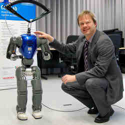 The small humanoid robot COMAN with Bielefeld University professor Jochen Steil.