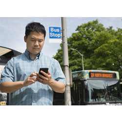 Ph.D. student Adrian deFreitas uses Impromptu, a system that accesses shared apps only when needed, such as a public transit app when the user is standing near a bus stop.