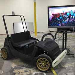 A SmartCart, in front of a monitor displaying a laser scan of the room.