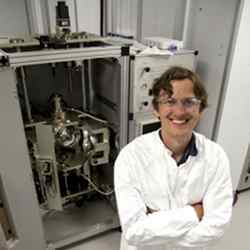 Stephen D. Wilson stands in front of a traditional floating zone furnace.