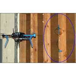 The drone is capturing data from an RFID moisture sensor installed in a building's wooden framework.
