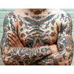 A man virtually covered with tatoos.