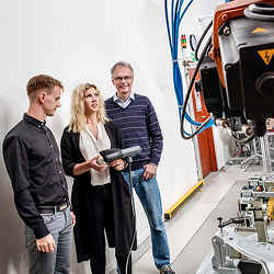 Kristofer Bengtsson (left), Emma Vidarsson, and Bengt Lennartson in the Robotics and Automation Laboratory at Chalmers University of Technology.