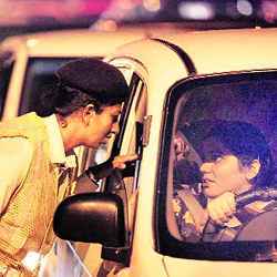 A constable checks a woman driver in Juhu, India. 