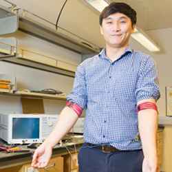 Electrical engineering Ph.D. student Jiwoong Park demonstrates communication from arm to arm using the magnetic field human body communication prototype.