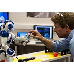 Researcher Peter Ford Dominey and the robot Nao.