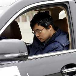 Researcher Zhang Zhao uses brain signal-reading equipment to direct a car to move forward  during a demonstration at Nankai University in Tianjin, China.