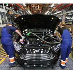 The Watch-Bot robot observes workers on an automotive assembly line.