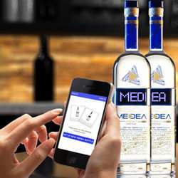 Using a smartphone to program scrolling LED displays on Medea Vodka bottles.