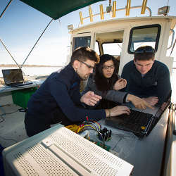 State University of New York at Buffalo students working on underwater wireless technology at Lake Erie, just south of Buffalo, NY.