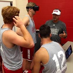 Indiana University football coach Kevin Wilson explains virtual reality training to his players.