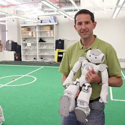 University of Texas computer science professor Peter Stone holds a member of his robot soccer team, UT Austin Villa. 