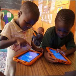 students in Uganda with tablet computers