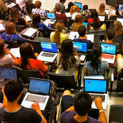 Laptops in use in a college classroom. 