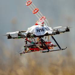 A drone returns to the side of a burn area for a reload of fireballs and the chemical to make them burn.