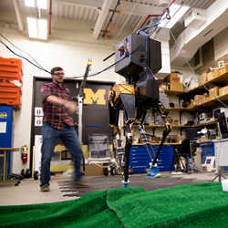 Bipedal robot MARLO and Ph.D. robotics student Ross Hartley. 